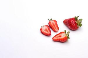 Fresh whole and some sliced strawberries isolated on white background. photo