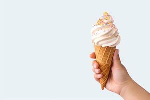 Hand holding delicious sprinkles ice cream in a crispy waffle cone with copy space. photo