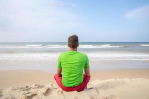 Back view of a man sitting on a beach. photo