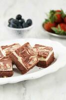 Red Velvet Cream Cheese Brownies on White Ceramic Plate photo