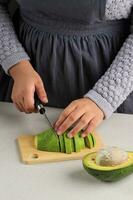 Female Slicing RIpe Avocado photo