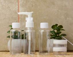 Transparent plastic container for cosmetics on the table, bottles for liquid cosmetics photo