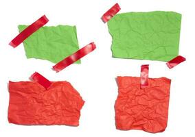 Green and red torn pieces of paper on a white isolated background photo