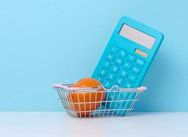 Miniature shopping cart and calculator photo