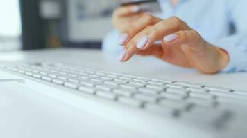 Female hands typing credit card number on computer keyboard. Woman making online purchase. Online payment service video