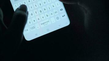 Hands typing text on smartphone close-up. Using smartphone close up at night. Communication concept video