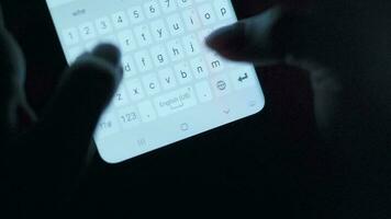 Hands typing text on smartphone close-up. Using smartphone close up at night. Communication concept video