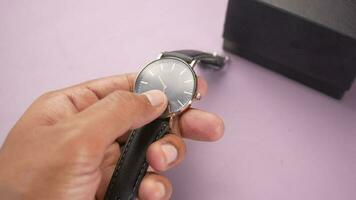 Men's wrist watches on hands with a box on table video