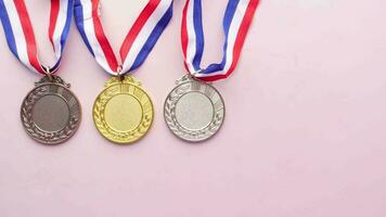 Gold, Silver and Bronze medals against color background video