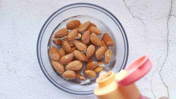 pouring water in a bowl of almond nut video