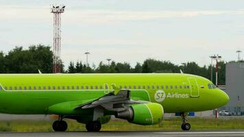 NOVOSIBIRSK, RUSSIAN FEDERATION JULY 15, 2022 - Commercial plane of S7 Airlines takeoff, side view. Airplane departure. Tourism and travel concept video
