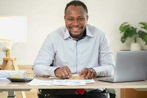 African American businessman smiling relaxed and crossed arms after analysis and research at home office photo