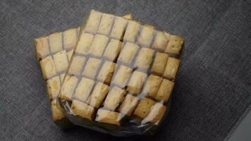 top view of sweet cookies in a plastic packet on wooden table video