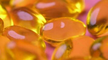 Fish oil supplement on orange background video