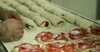 Baker Rolling Dough With Salami Cuts In The Bakery Kitchen - Salami Bread Rolls - close up video