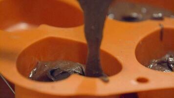 Filling Of Chocolate Mixture To Orange Heart-Shaped Mould - Closeup Shot video