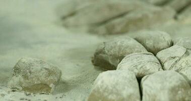 Baker Rolling And Shaping Dough Over Wheat Flour. - close up shot video