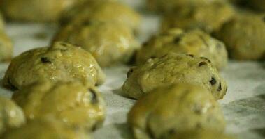 Tray Of Raisin Cookie Dough Brushed With Egg Wash Before Baking - close up, slider video