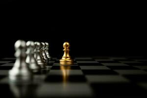 Golden Chess pawn standing in front of other chess, Concept of a leader must have courage and challenge in the competition, leadership and business vision for a win in business games photo