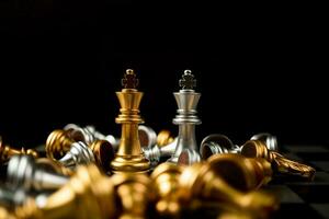 el ajedrez rey dorado y plateado es el último en pie en el tablero de ajedrez, concepto de liderazgo empresarial exitoso, confrontación y pérdida foto