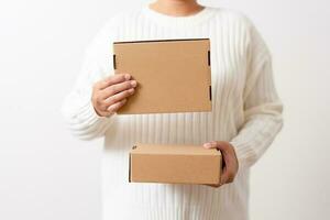 Woman hands holding present box with a ribbon bow. Concept of gift  box minimalist style. Showing brown cardboard boxes delivery someone in special occasions or parcel deliver service. photo