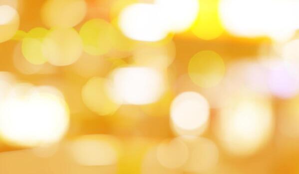 Blurred yellow and golden bokeh background. Blur abstract background of yellow light. Yellow light with beautiful pattern of circle bokeh. Golden bokeh abstract background for festive decoration. photo