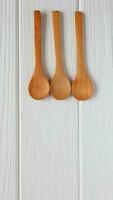 Wooden spoons mockup on white wood table, copy space photo