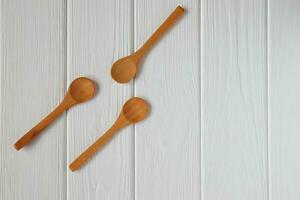 Wooden spoons mockup on white wood table, copy space photo