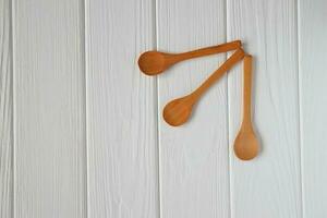 Wooden spoons mockup on white wood table, copy space photo