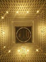 Bandung, Indonesia - January 2023. Wicker basket with light bulbs in the interior of the praying room in the Al Jabbar Mosque which carrying the word Allah in Arabic photo