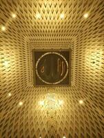 Bandung, Indonesia - January 2023. Wicker basket with light bulbs in the interior of the praying room in the Al Jabbar Mosque which carrying the word Allah in Arabic photo