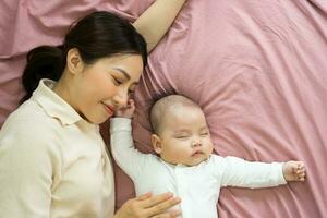 Asian mother and newborn baby feet are smiling and happy photo