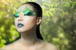 beautiful women with perfect art make up and long false eyelashes made from feathers photo