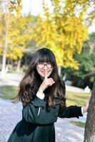 Pretty Chinese girl wearing coat in action photo