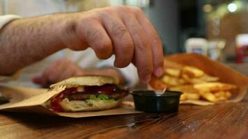 Eating fastfood hamburger fried french video