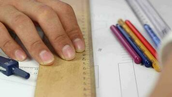 Architects hand drawing on sketch using ruler and color pencil in desk, man working for architectural project with equipment, selective focus video