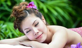 Beautiful Asian girl doing spa massage photo