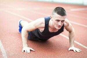 Handsome fit man exercising push up photo