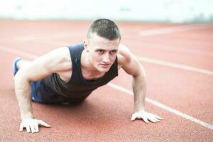 Handsome fit man exercising push up photo