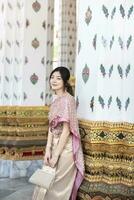 Beautiful Asian girl in Thai traditional costume at temple photo