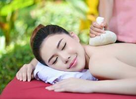 Beautiful Asian girl doing spa massage photo