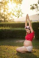 Image of pregnant woman touching her belly with hands photo