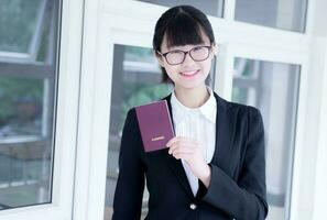 Modern business woman in the office, holding passport photo