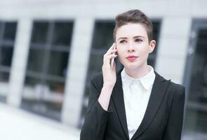 Modern business woman talking on phone photo