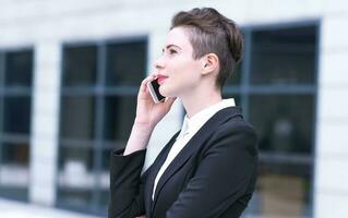 Modern business woman talking on phone photo