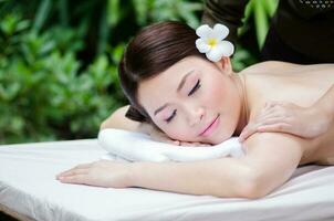 Beautiful Asian woman doing spa massage photo