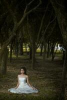 Asian Girl in wedding dress in the forest photo