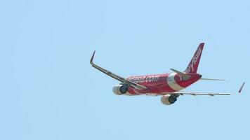 PHUKET, THAILAND FEBRUARY 23, 2023 - Commercial plane Airbus A320, HS BBO of AirAsia take off and climbing, retract landing gear. Cinematic shot of airplane leaving video