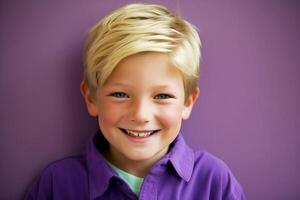 Portrait, smiling boy with blond hair, schoolboy in purple clothes. photo