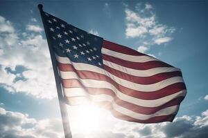 An American flag on a flagpole against a blue sky. photo